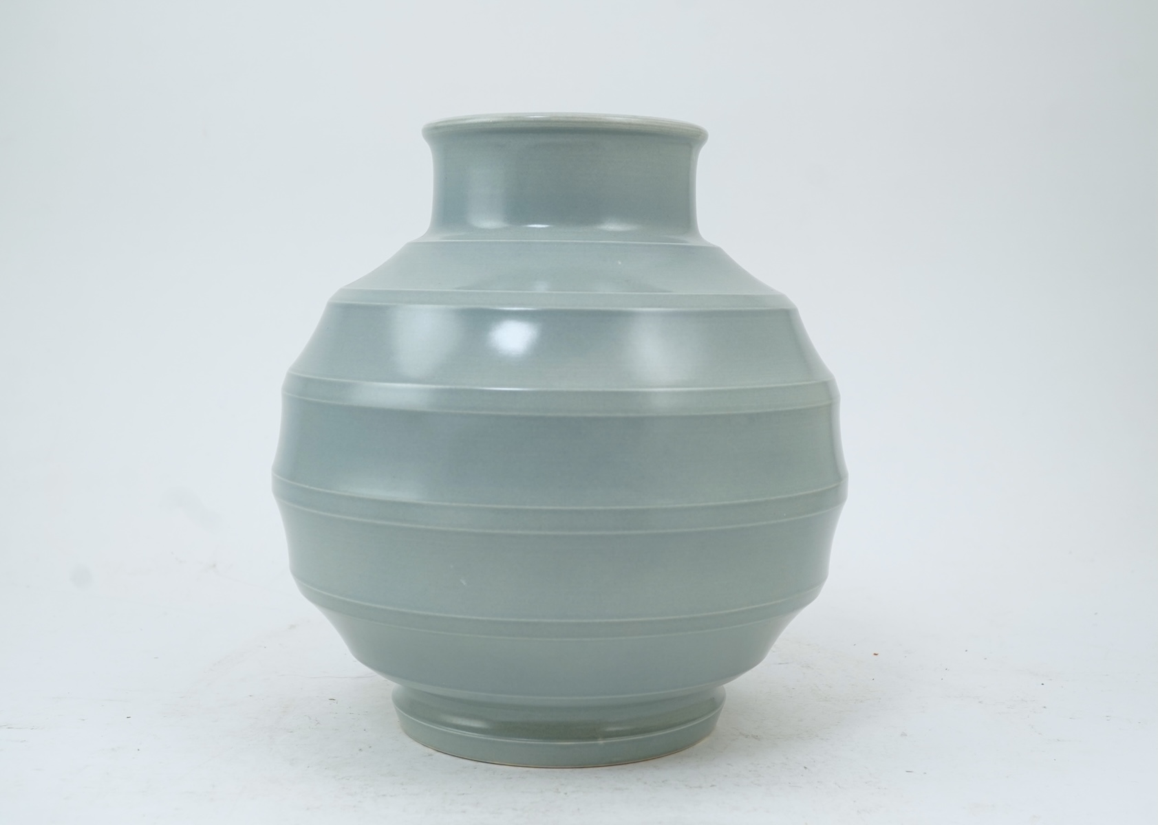 Keith Murray MC RDI FRIBA (New Zealand/British, 1892-1981) for Wedgwood: A pale blue glazed globe or 'bomb' vase